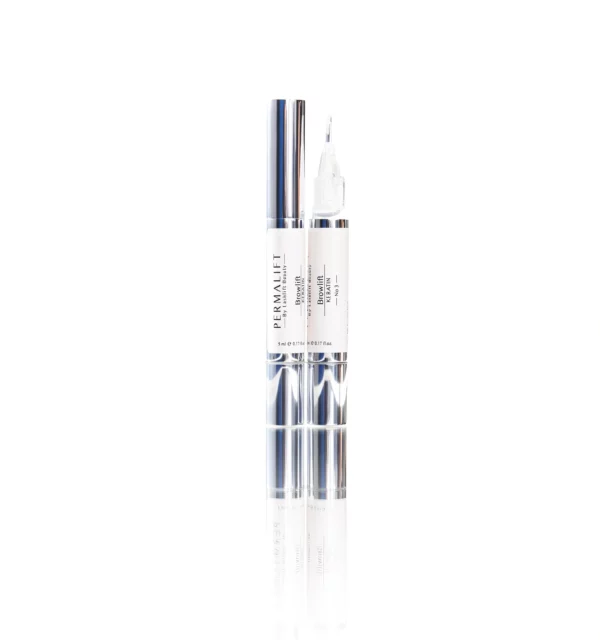 Two Permalift Brow Lift Keratin Lotion pens, one capped and one uncapped, designed to enhance brow health and appearance as the final step in the brow lamination process