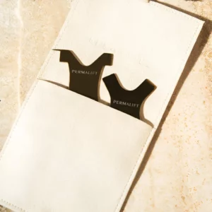 Two Permalift Y-combs resting in a beige suede pouch on a neutral background, designed for precision in lash lift treatments