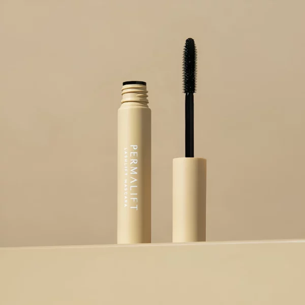 Permalift Lash Lift Mascara in a beige tube with a black brush, designed for enhancing lash separation and length, displayed against a soft beige background