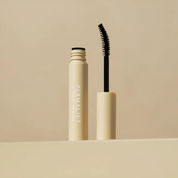 Permalift Lash Lift Mascara in a beige tube with a black brush, designed for enhancing lash volume and curl, displayed against a soft beige background