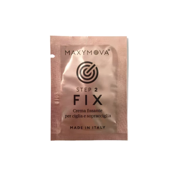 Maxymova Step 2 Fix sachet, a fixing cream for eyelash and eyebrow lamination, labeled in Italian, in a metallic rose-colored packet. Sets lashes and brows after lifting for a long-lasting shape