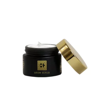 Brow Code Brow Scrub in an open black and gold jar with whipped formula visible