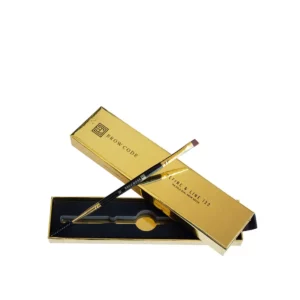 Brow Code 122 Define & Line brush with a spoolie and angled tip, displayed in gold packaging.