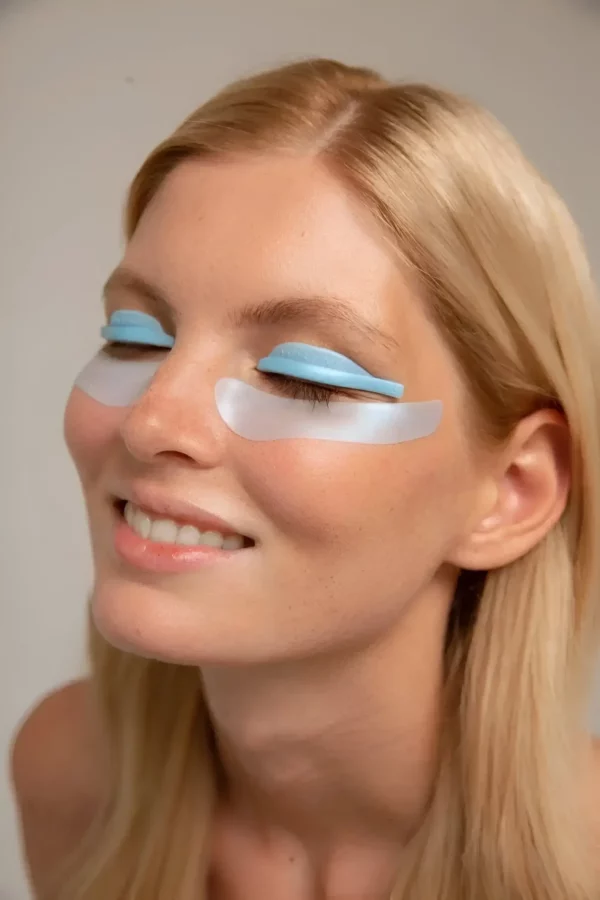 Model wearing blue Katya Vinog silicone patches during a lash treatment