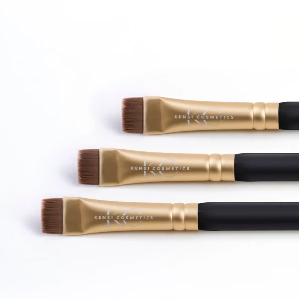 Set of three Kensi Cosmetics flat highlighter brushes with gold ferrules and black handles, designed for precise makeup application.