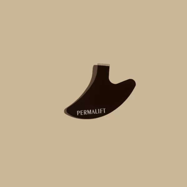Permalift Ergonomic Lash Lift Y-Comb with a sleek, curved black design and fine metal teeth, displayed on a neutral beige background