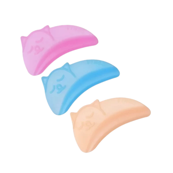 Three lash lift shields in pink, blue, and peach with playful cat face imprints, providing flexibility and comfort for bottom lash lifts