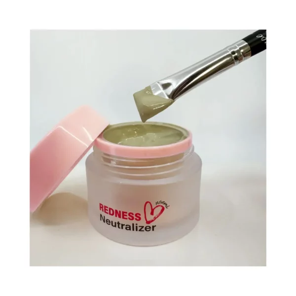 Noemi Redness Neutralizer in an open frosted jar with a pink lid, showing its green-toned gel texture on a brush